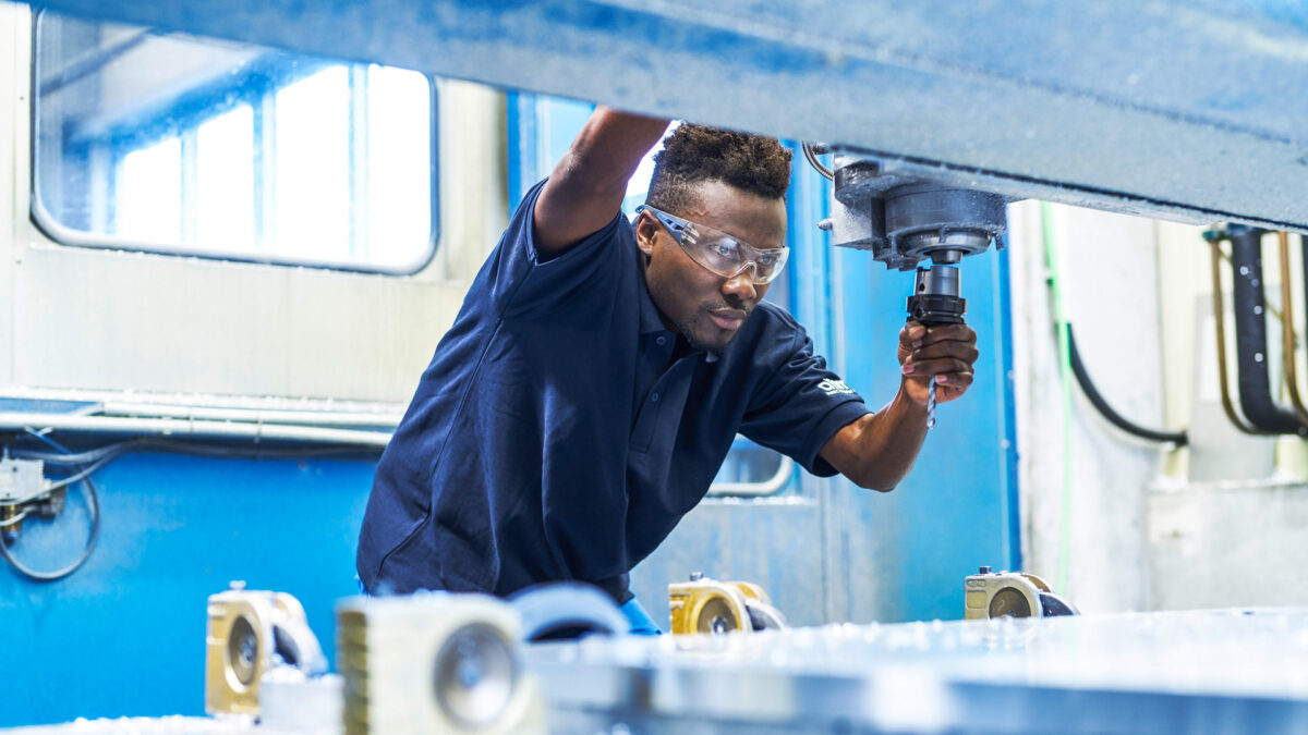 Alimex employee works with metal and drill